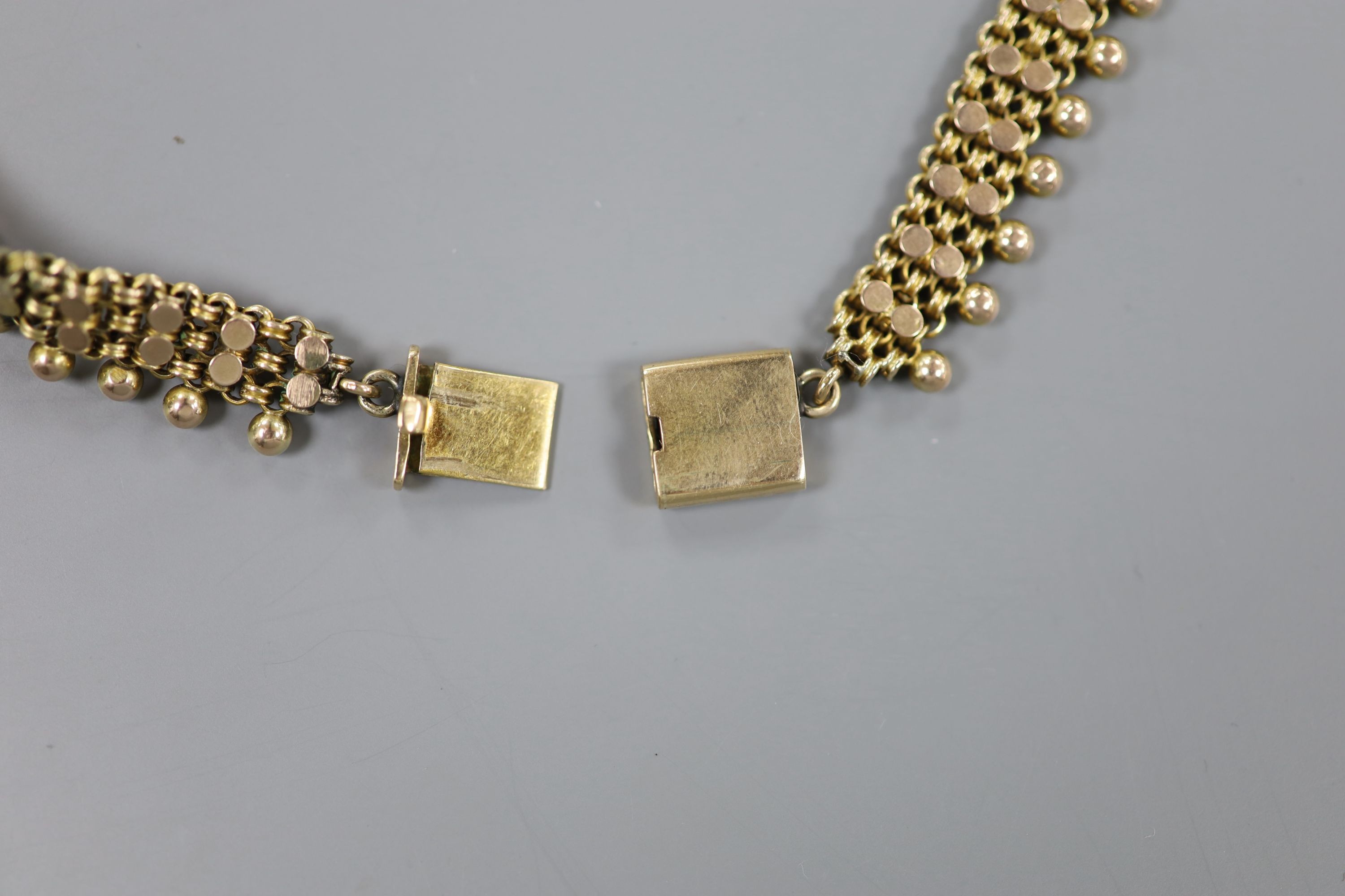 An early 20th century yellow metal fancy link and bead choker necklace, 42cm